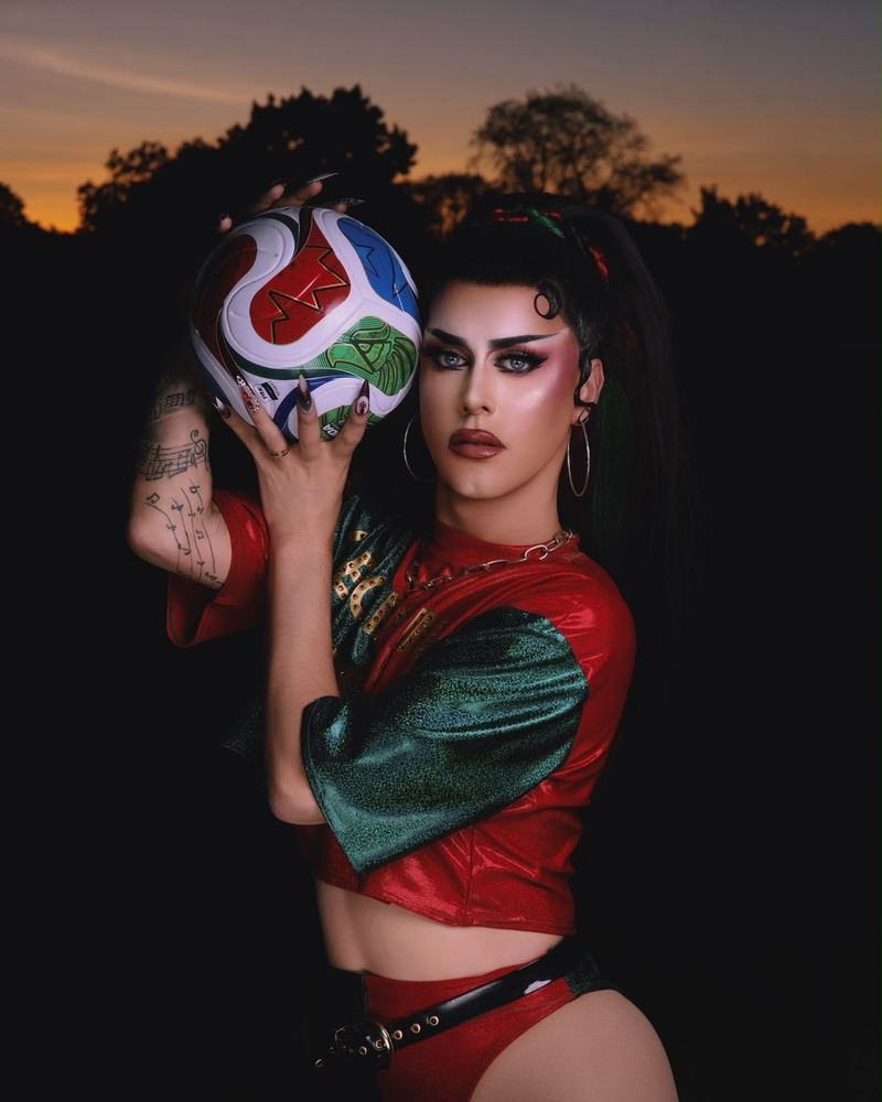 Georgina as Goleadora, holding a football in a red and green kit