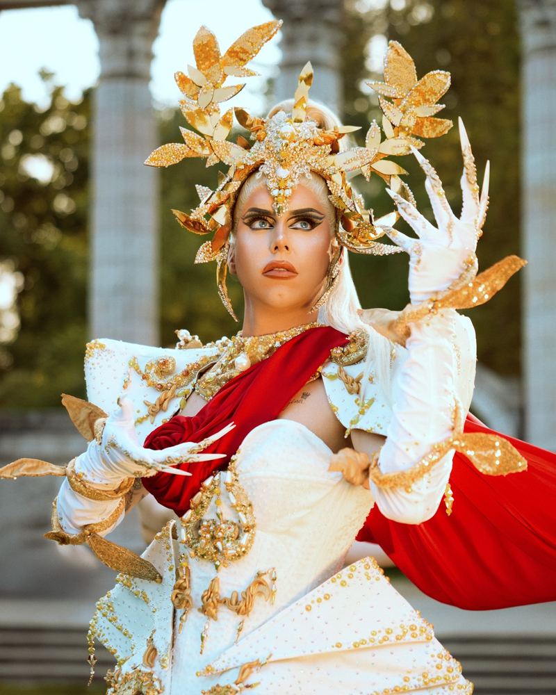 Georgina as Rainha, in a gold leaf headdress and white gown